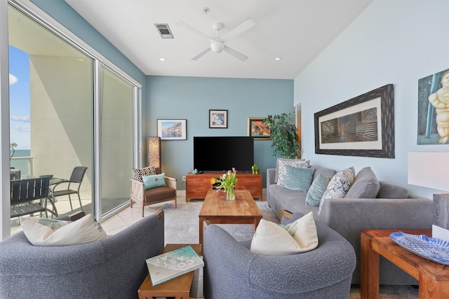 tiled living room featuring visible vents and ceiling fan