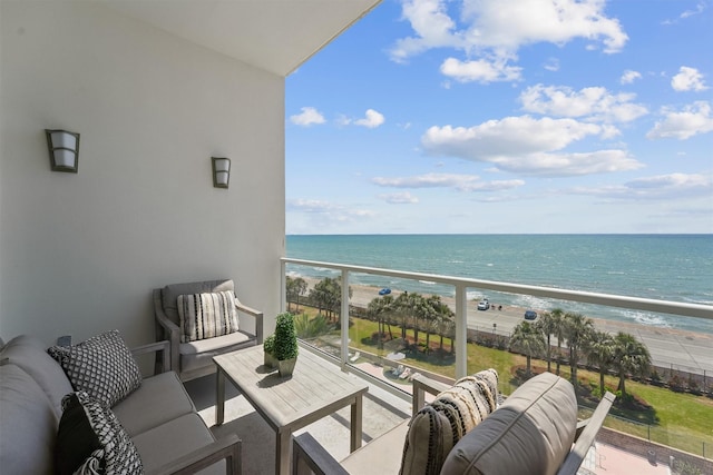 balcony with a beach view, outdoor lounge area, and a water view