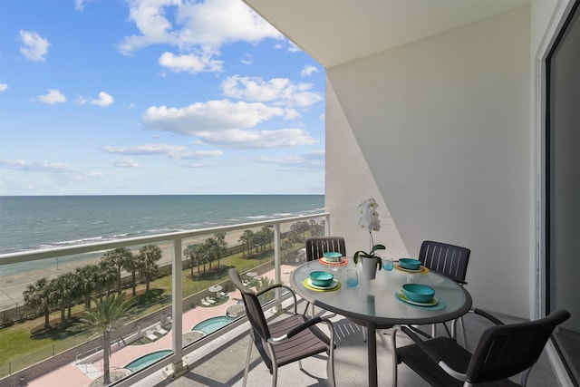 balcony with a beach view and a water view
