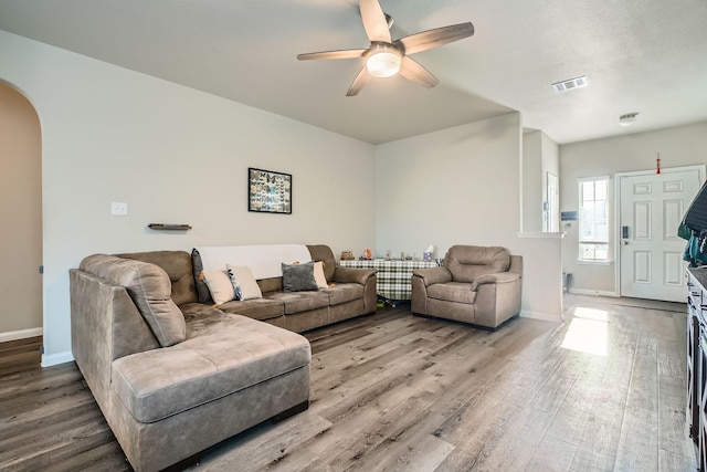 25639 Brooklyn Ln, Porter, TX 77365 - living area featuring ceiling fan, arched walkways, visible vents, wood finished floors, and baseboards
