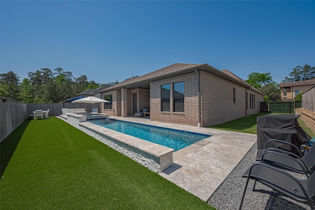 1011 Oak Briar Ln, Conroe, TX 77384 - rear view of property featuring brick siding, a patio area, and a pool with connected hot tub