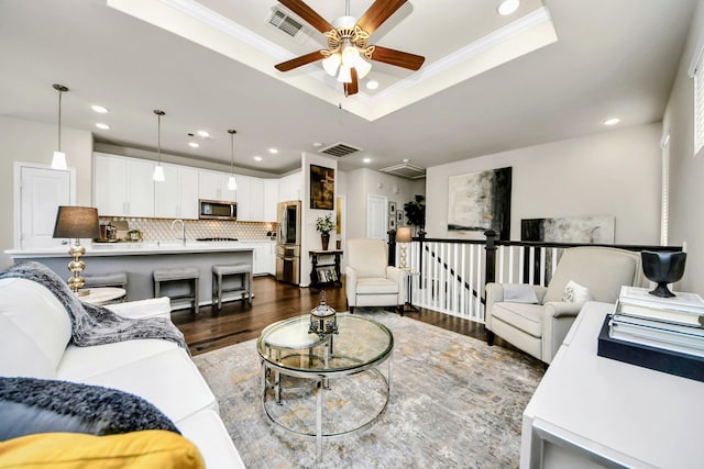 3119 Longleaf Meadows Dr, Houston, TX 77063 - living area with a raised ceiling, ceiling fan, recessed lighting, dark wood-style floors, and ornamental molding