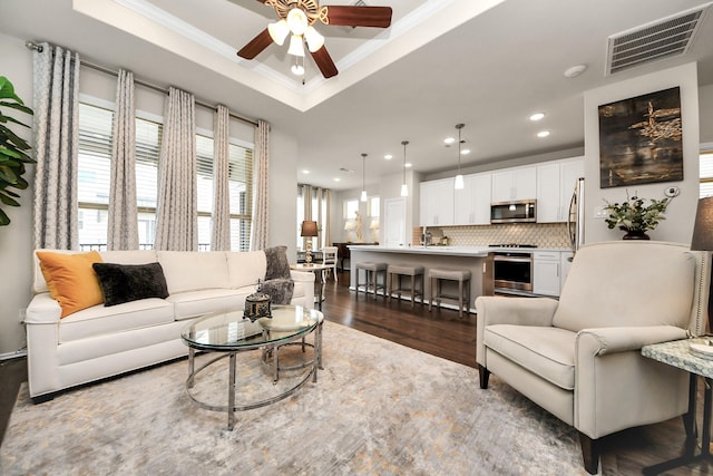3119 Longleaf Meadows Dr, Houston, TX 77063 - living room with ceiling fan, dark wood finished floors, recessed lighting, a tray ceiling, and ornamental molding