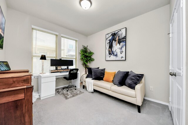 carpeted office featuring baseboards