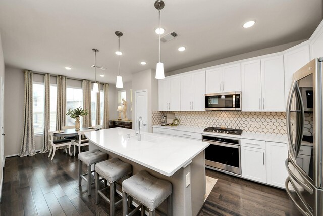 kitchen featuring decorative backsplash, appliances with stainless steel finishes, a sink, light countertops, and white cabinets