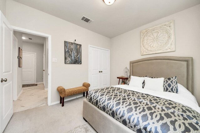 bedroom featuring baseboards, visible vents, marble finish floor, and a closet