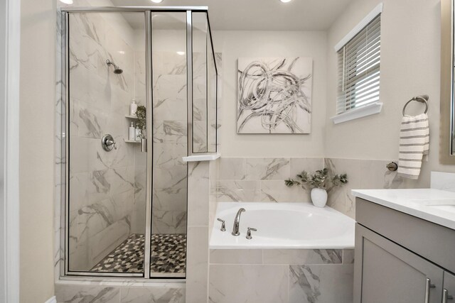 full bath featuring marble finish floor, a marble finish shower, a bath, and vanity