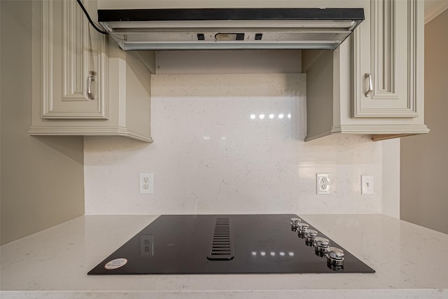 215 Wood Circle Ln, Houston, TX 77015 - kitchen featuring cream cabinets, black electric cooktop, light stone countertops, and under cabinet range hood
