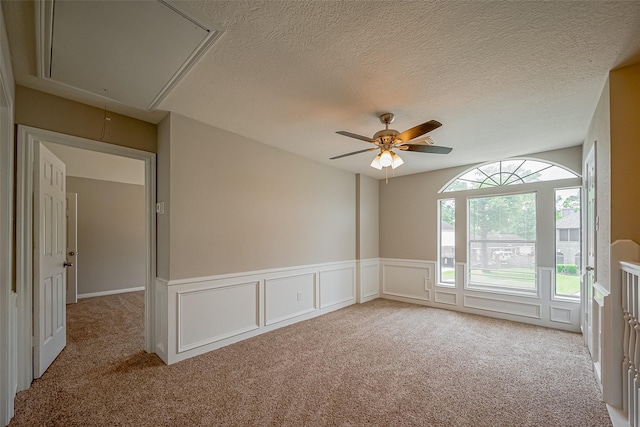 215 Wood Circle Ln, Houston, TX 77015 - empty room featuring attic access, carpet flooring, ceiling fan, wainscoting, and a textured ceiling