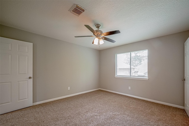 215 Wood Circle Ln, Houston, TX 77015 - empty room with light carpet, ceiling fan, baseboards, and a textured ceiling