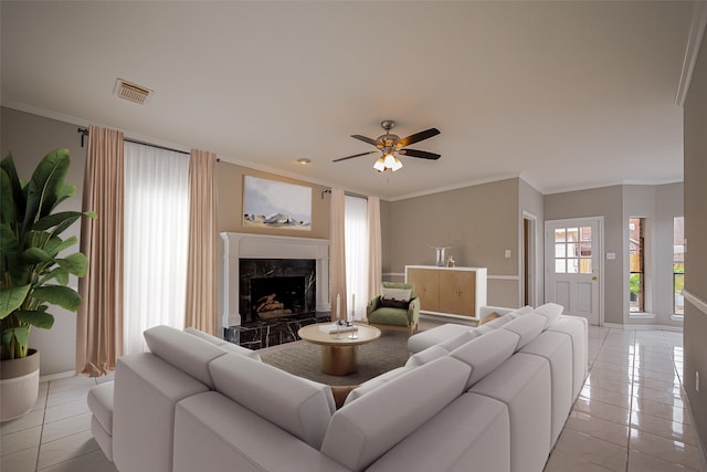 215 Wood Circle Ln, Houston, TX 77015 - living room featuring light tile patterned floors, crown molding, a premium fireplace, ceiling fan, and baseboards