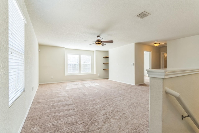 315 Prato Brezza, San Antonio, TX 78253 - unfurnished room featuring ceiling fan, a textured ceiling, baseboards, and light carpet