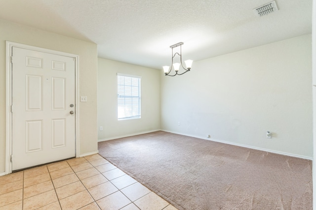 315 Prato Brezza, San Antonio, TX 78253 - foyer featuring light carpet, a chandelier, baseboards, and light tile patterned flooring