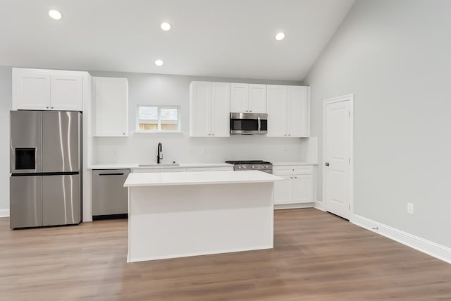 25759 Hickory Ln, Splendora, TX 77372 - kitchen with stainless steel appliances, white cabinetry, a center island, and recessed lighting