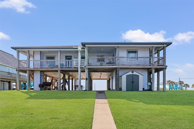 back of property featuring a storage shed, a carport, an outdoor structure, and a lawn