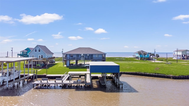exterior space featuring a water view, a yard, boat lift, and a dock