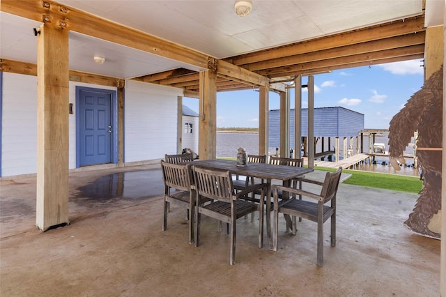 view of patio / terrace featuring a water view and outdoor dining space