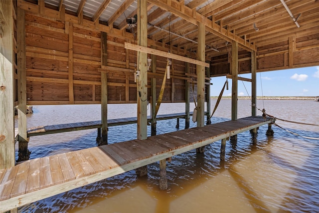 dock area with a water view and boat lift