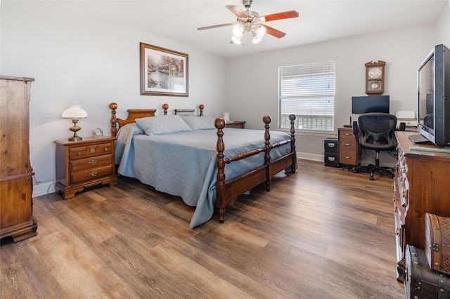 bedroom with baseboards, a ceiling fan, and wood finished floors