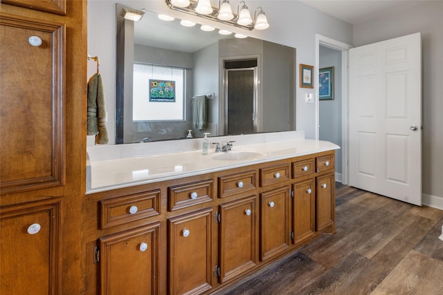 full bath featuring vanity, a stall shower, and wood finished floors