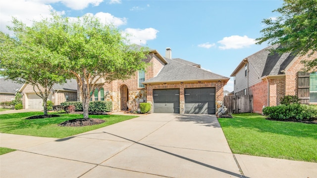 19810 Quarry Stone Ln, Richmond, TX 77407 - view of front of house featuring a front yard, brick siding, driveway, and an attached garage