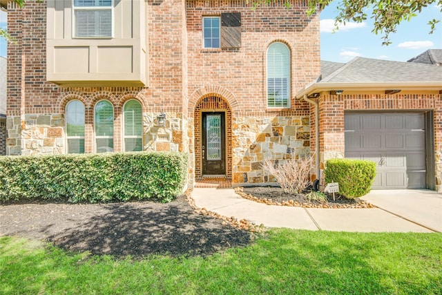 19810 Quarry Stone Ln, Richmond, TX 77407 - view of front of property with concrete driveway, stone siding, brick siding, a garage, and a shingled roof