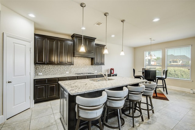 19810 Quarry Stone Ln, Richmond, TX 77407 - kitchen with a sink, light tile patterned floors, decorative backsplash, and stainless steel gas stovetop