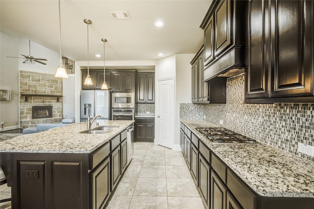 19810 Quarry Stone Ln, Richmond, TX 77407 - kitchen with a ceiling fan, visible vents, appliances with stainless steel finishes, a sink, and decorative backsplash