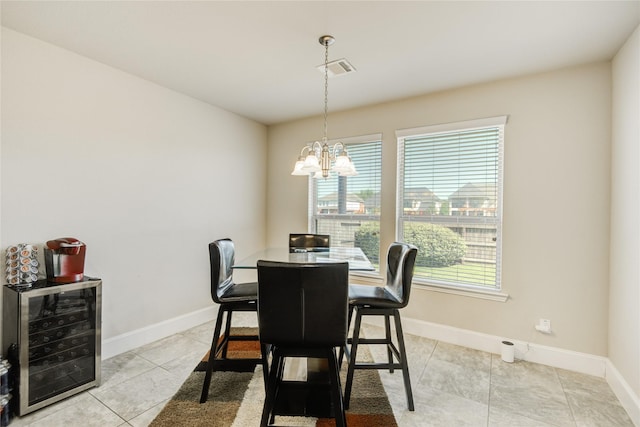 19810 Quarry Stone Ln, Richmond, TX 77407 - dining space with visible vents, light tile patterned floors, baseboards, a notable chandelier, and beverage cooler
