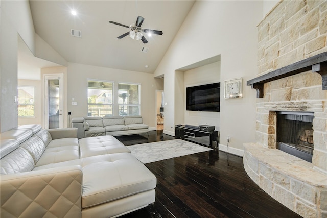 19810 Quarry Stone Ln, Richmond, TX 77407 - living area with a stone fireplace, a ceiling fan, visible vents, dark wood finished floors, and high vaulted ceiling