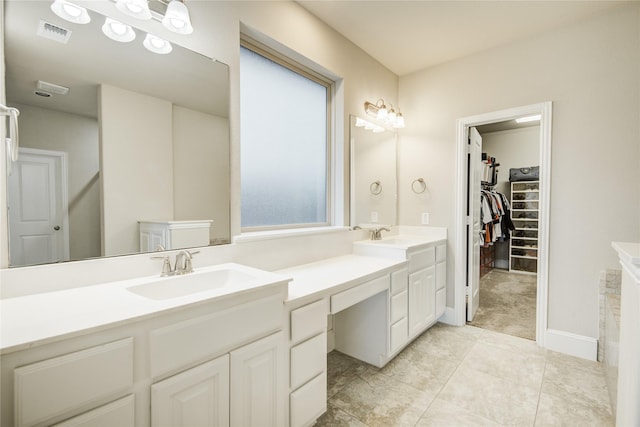 19810 Quarry Stone Ln, Richmond, TX 77407 - full bath with a walk in closet, double vanity, a sink, and visible vents