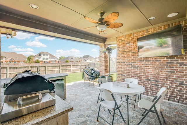19810 Quarry Stone Ln, Richmond, TX 77407 - view of patio with a residential view, fence, outdoor dining area, and an outdoor kitchen