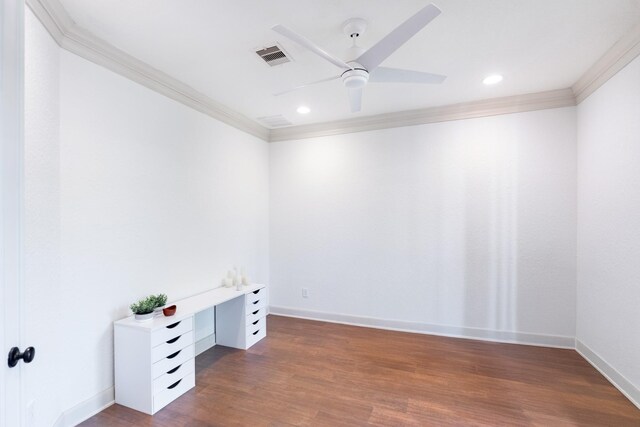 spare room with ceiling fan, baseboards, wood finished floors, visible vents, and ornamental molding