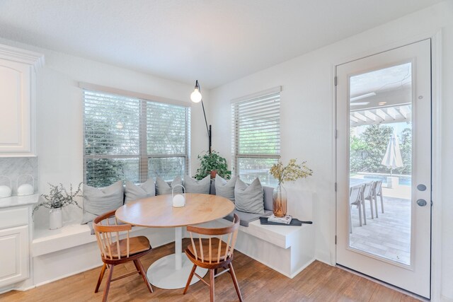 dining room with light wood-style floors and breakfast area