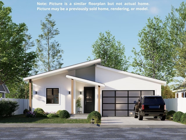 view of front facade featuring an attached garage, driveway, and fence