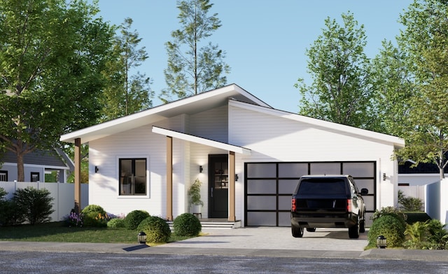 view of front facade featuring an attached garage, fence, and driveway