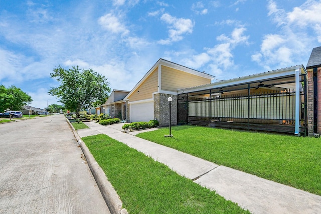 6430 Grandvale Dr, Houston, TX 77072 - view of front of house featuring a front yard, driveway, an attached garage, and ceiling fan