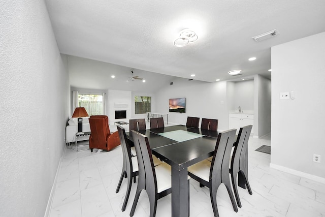 6430 Grandvale Dr, Houston, TX 77072 - dining area featuring baseboards, a textured ceiling, a ceiling fan, visible vents, and marble finish floor