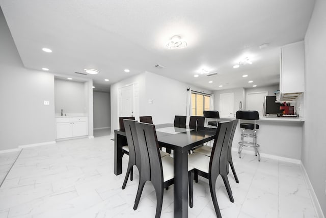 6430 Grandvale Dr, Houston, TX 77072 - dining room with baseboards, recessed lighting, marble finish floor, and a barn door