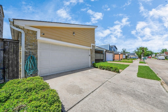 6430 Grandvale Dr, Houston, TX 77072 - exterior space featuring concrete driveway, stone siding, and a garage