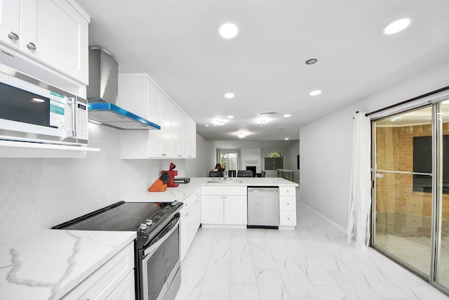 6430 Grandvale Dr, Houston, TX 77072 - kitchen with a peninsula, recessed lighting, wall chimney range hood, and stainless steel appliances
