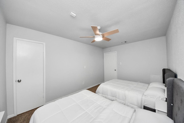 6430 Grandvale Dr, Houston, TX 77072 - bedroom with visible vents, baseboards, ceiling fan, a textured ceiling, and carpet flooring