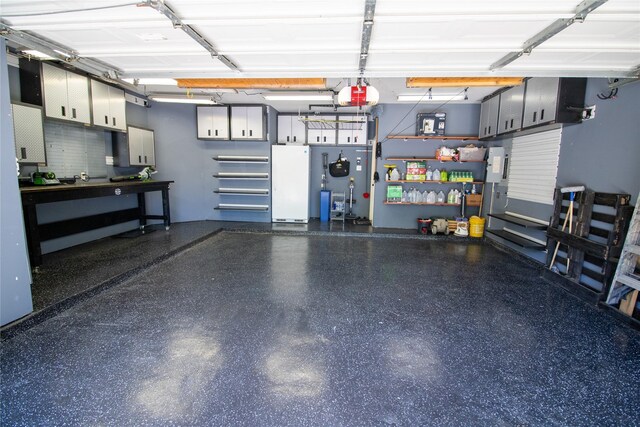 garage featuring a workshop area and a garage door opener