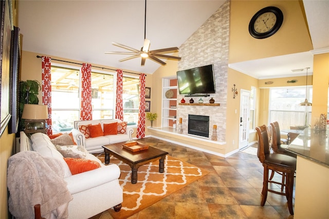 living room featuring a ceiling fan, a large fireplace, high vaulted ceiling, baseboards, and crown molding