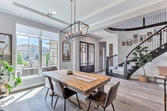 dining room featuring visible vents, wood finished floors, stairs, french doors, and baseboards