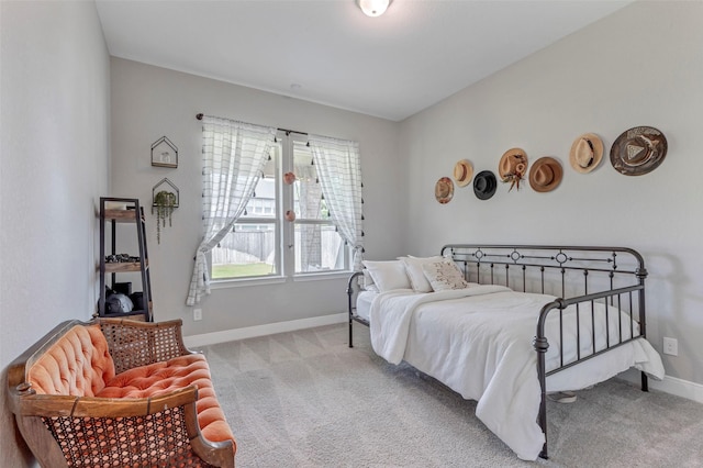 bedroom with baseboards and carpet