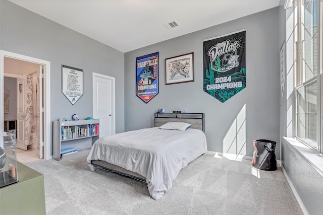 carpeted bedroom featuring visible vents and baseboards