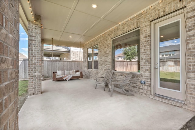 view of patio featuring an outdoor living space and fence