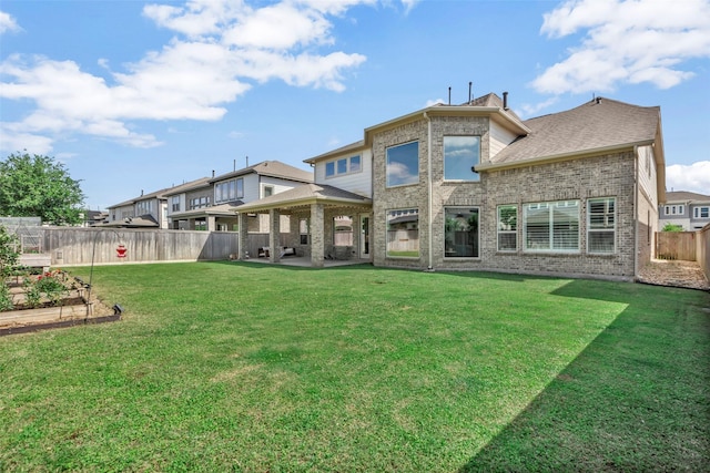 back of house featuring a patio, a garden, a fenced backyard, a gazebo, and a lawn