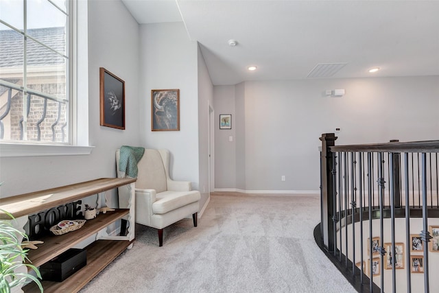 sitting room featuring recessed lighting, carpet flooring, baseboards, and an upstairs landing